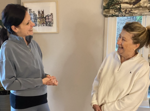 Rachel Thompson, physiotherapist, talking and laughing with a patient during a relaxed consultation Image Title: